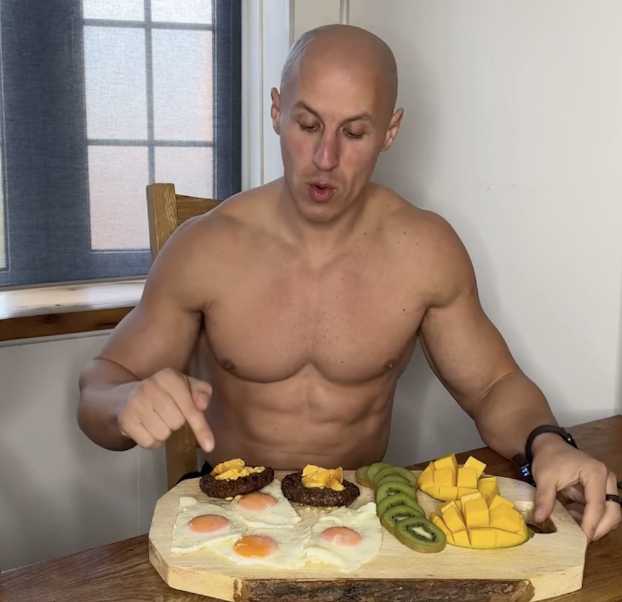 A bald man with abs and a lot of eggs