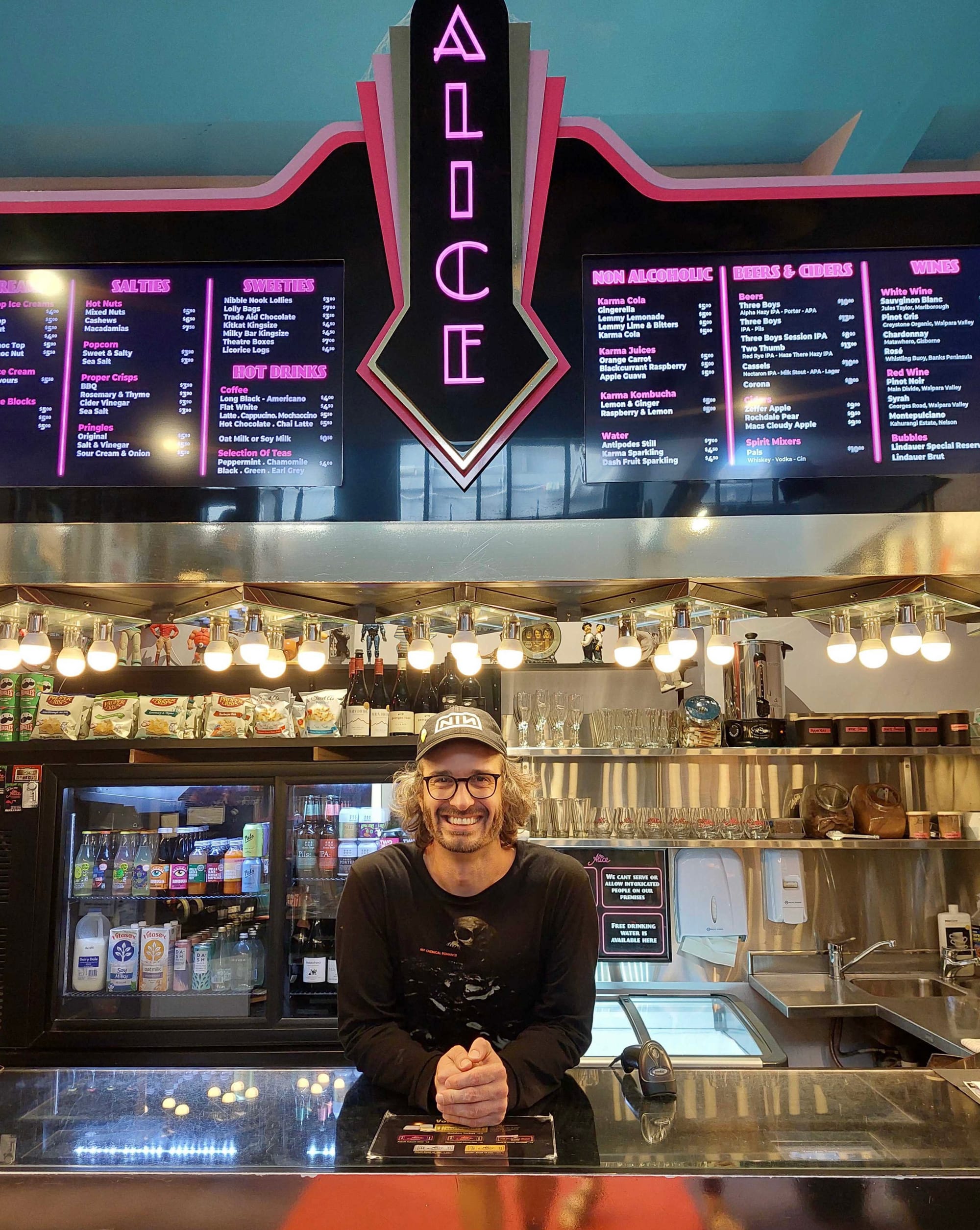 Me standing behind counter of The Alice in Christchurch
