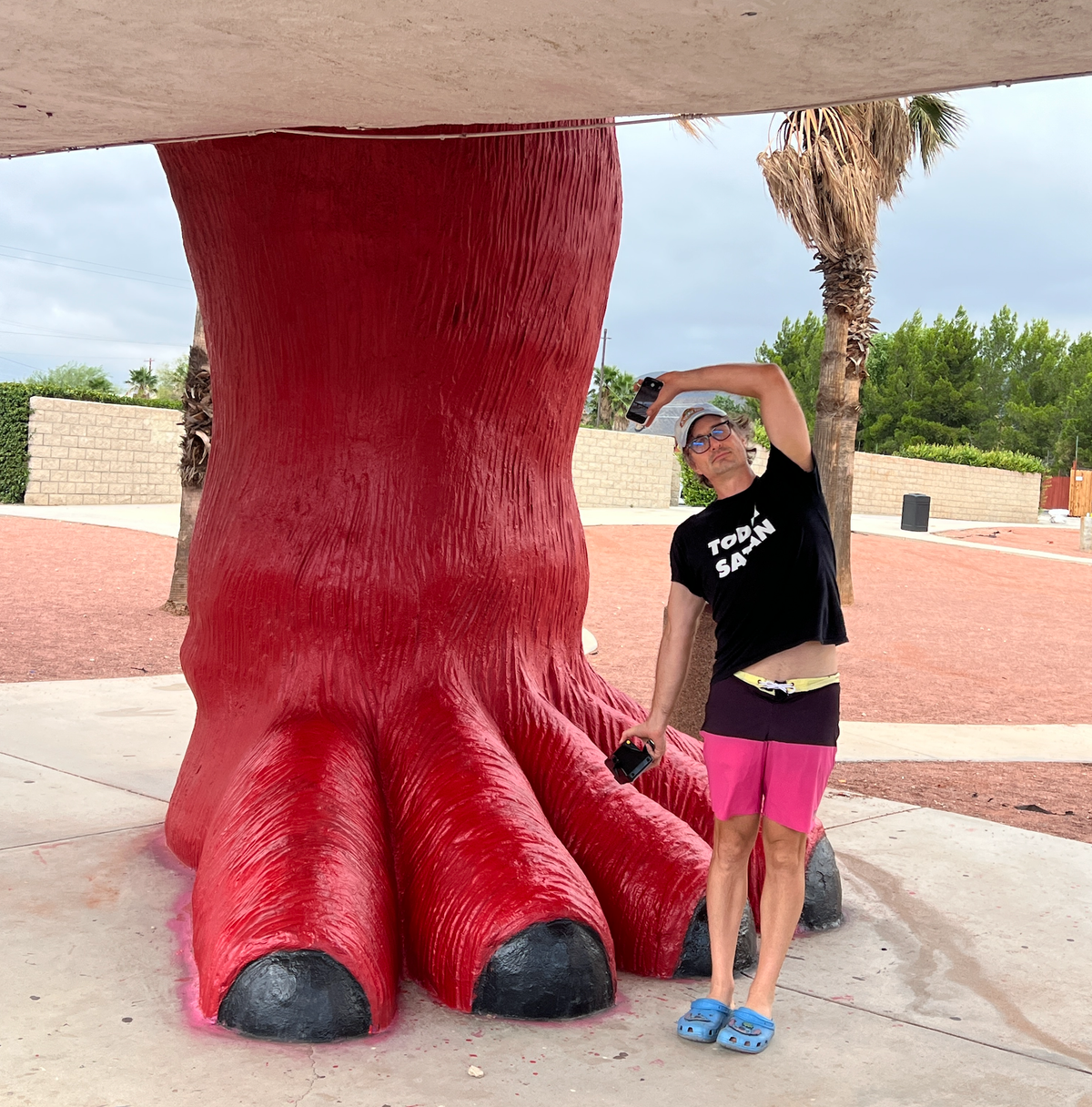 Me next to a giant dinosaur foot