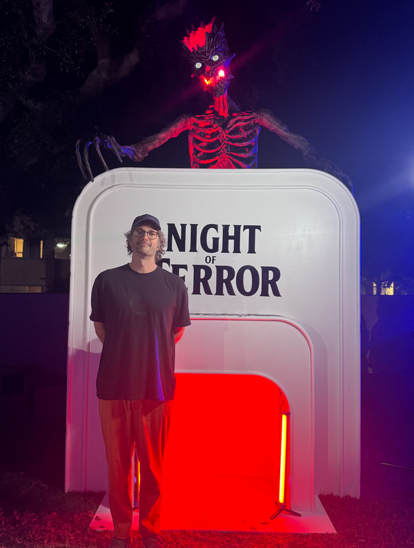 Me in front of a "Night of Terror" sign