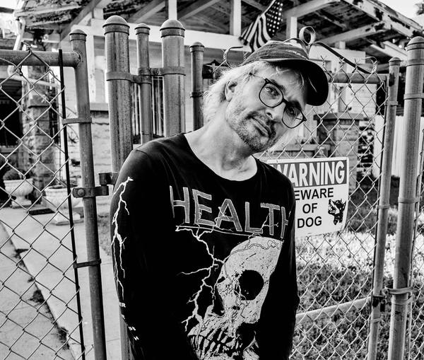 Me outside a fenced off building