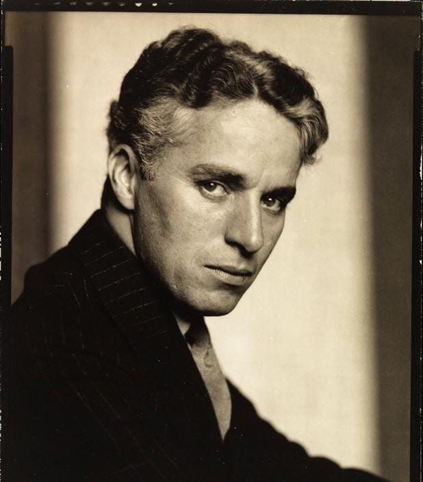 A silver gelatin portrait of Charlie Chaplin in 1925. Without his signature toothbrush mustache, Chaplin the man concentrates his gaze towards the camera.