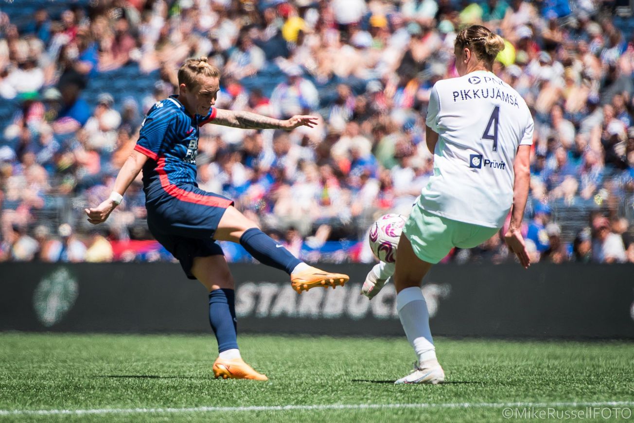 Jess Fishlock challenges for a ball against Racing Louisville’s Elli Pikkujämsä in a game in July 2023. 