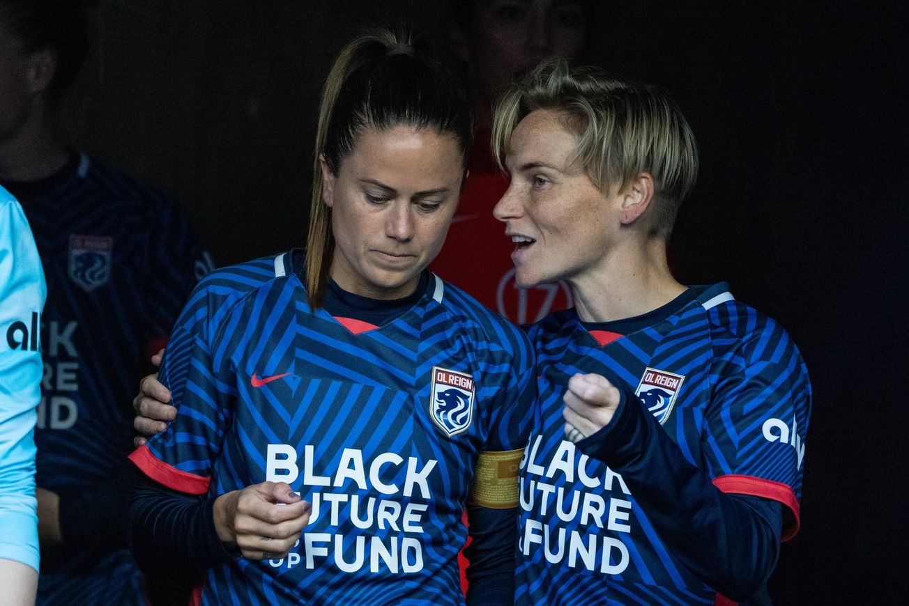 Lu Barnes and Jess Fishlock converse ahead of an OL Reign game.