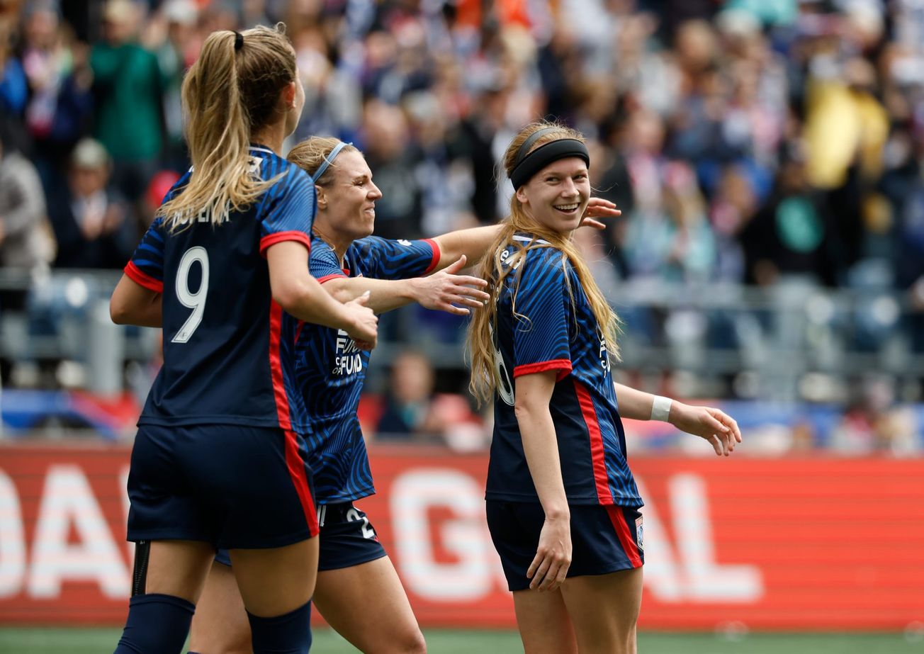 Bethany Balcer smiles and looks back at teammate Jordyn Huitema after scoring a goal