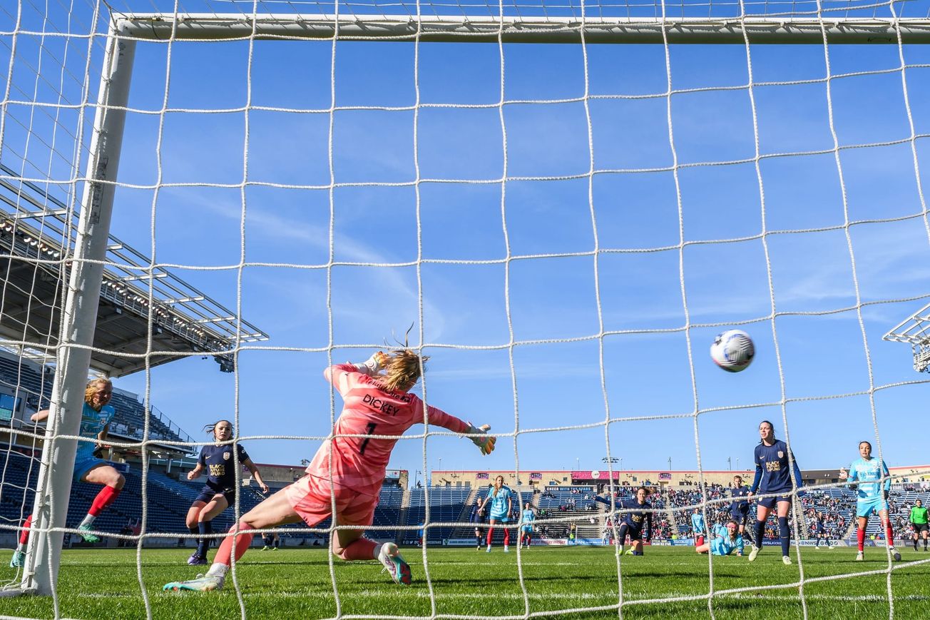 Goalkeeper Claudia Dickey and the Reign defense watches as a Maximiliane Rall header gets past them for a goal.