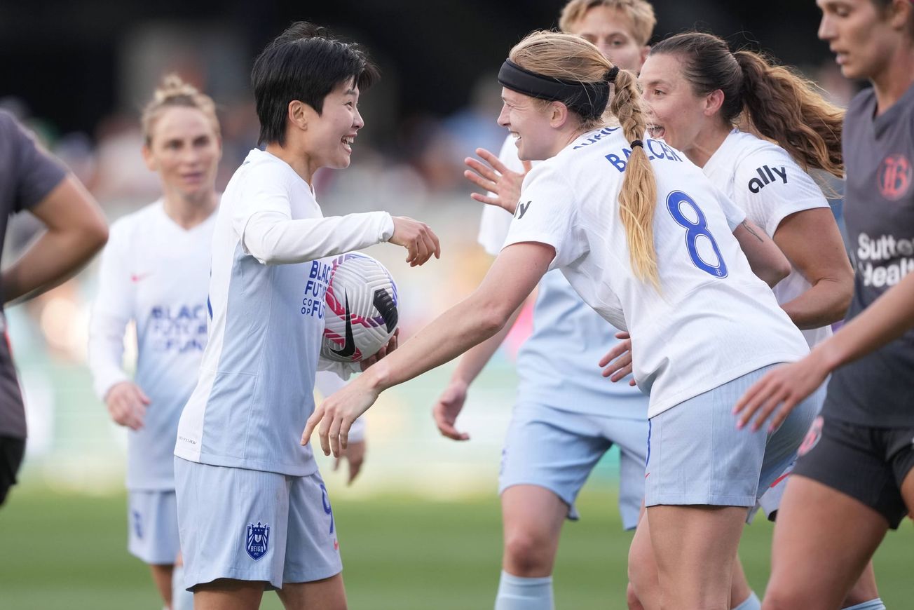Ji So-Yun and Bethany Balcer of Seattle Reign celebrate Balcer scoring a goal against Bay FC in April 2024.