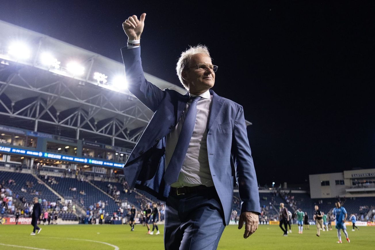 Sounders head coach Brian Schmetzer giving a thumbs-up to traveling supporters after a win in Philadelphia
