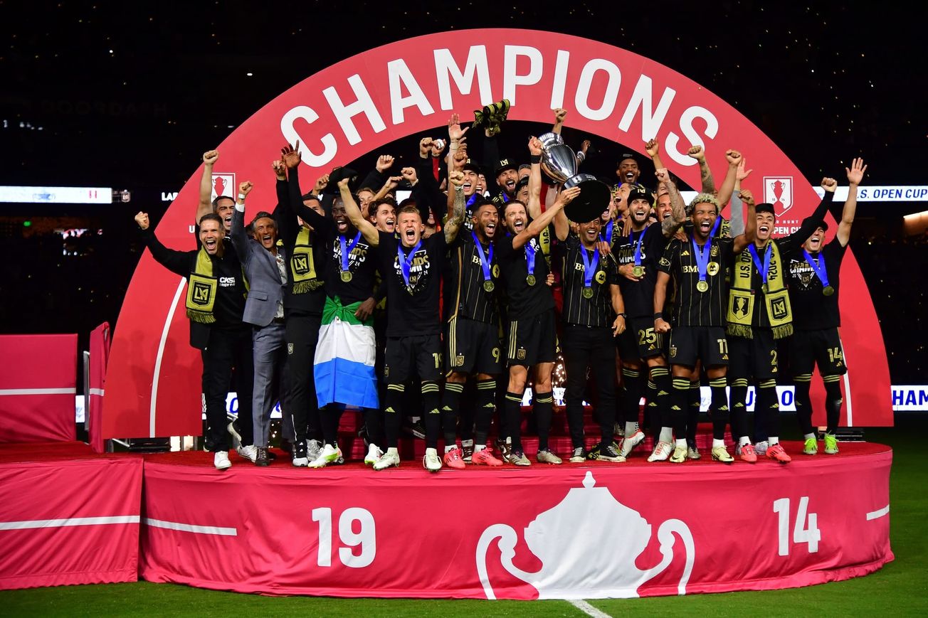 LAFC players lift the US Open Cup trophy after winning the 2024 final.