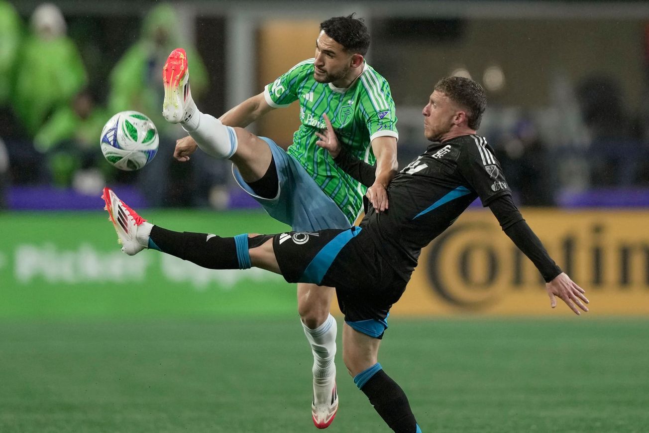 Cristian Roldan challenges for a ball while leaping with a raised le