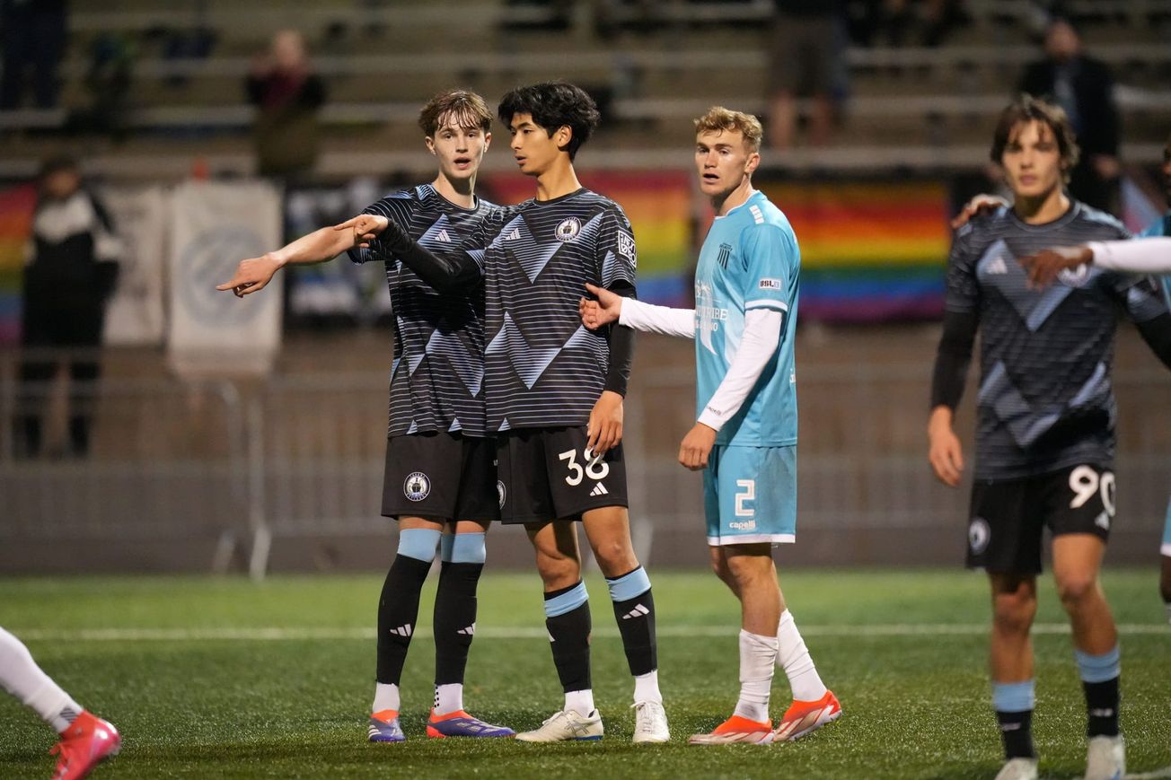 Stuart Hawkins and Kaito Yamada prepare to defend a set piece