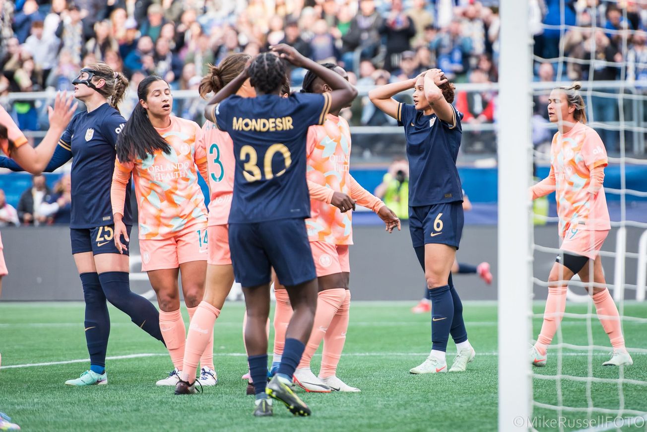 Frustrated Seattle Reign players react to a missed shot on goal late in a game against Orlando Pride.
