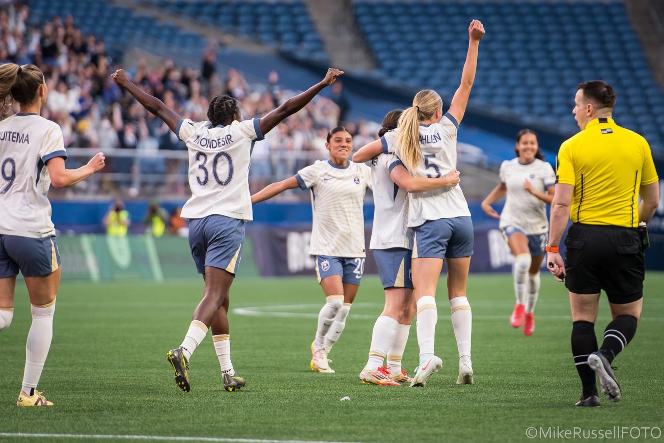 Reign forward Maddie Dahlien celebrates her goal against Portland with teammates