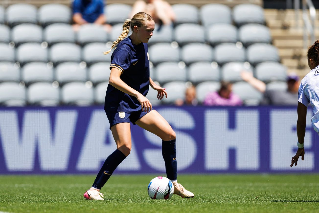 Reign forward Maddie Dahlien dribbles against Racing Louisville in a May 2025 match.