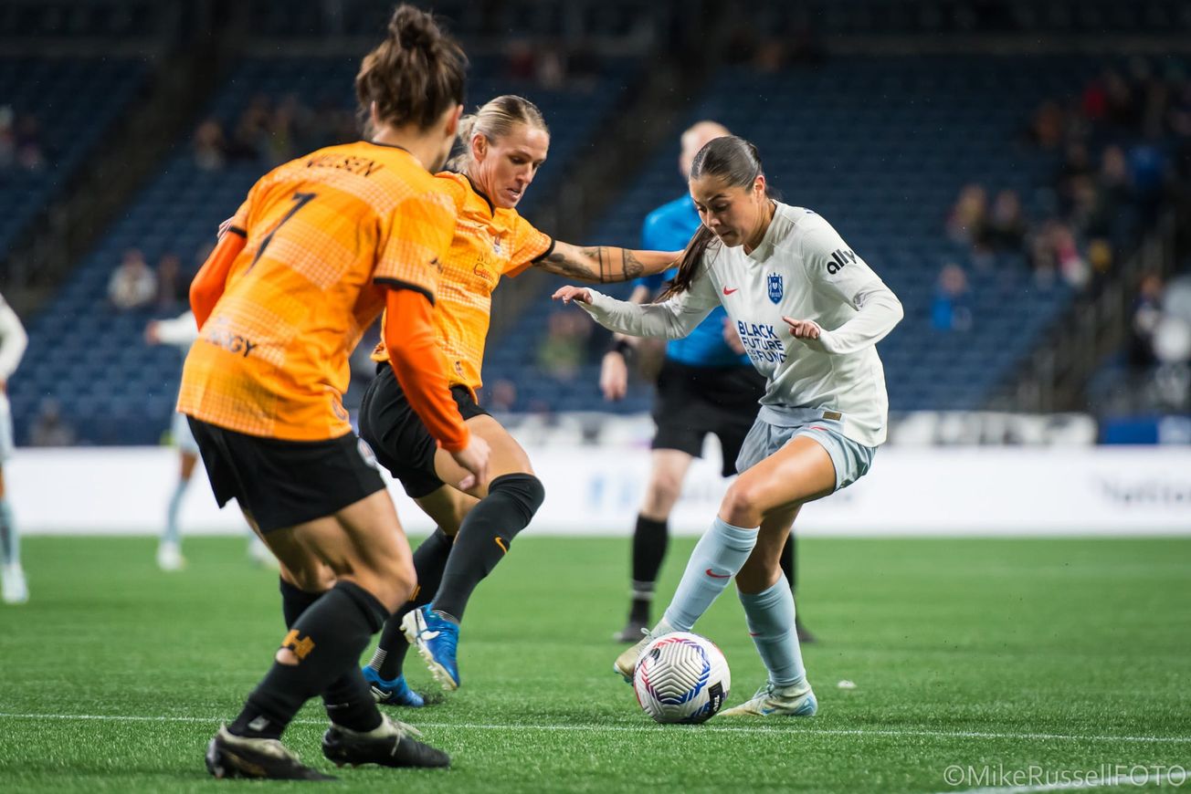 Reign winger Emeri Adames dribbles against the Houston Dash in an October 2024 match at Lumen Field.