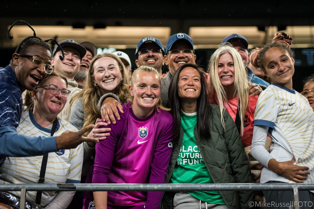 Claudia Dickey celebrates with fans after a Seattle Reign victory over KC Current in May 2025.