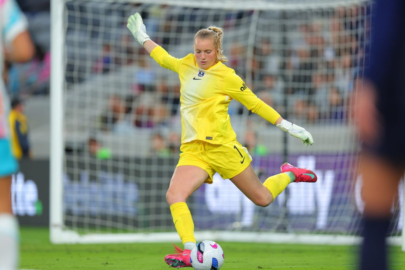 Reign goalkeeper Claudia Dickey kicks the ball in a match against San Diego Wave FC in June 2025.