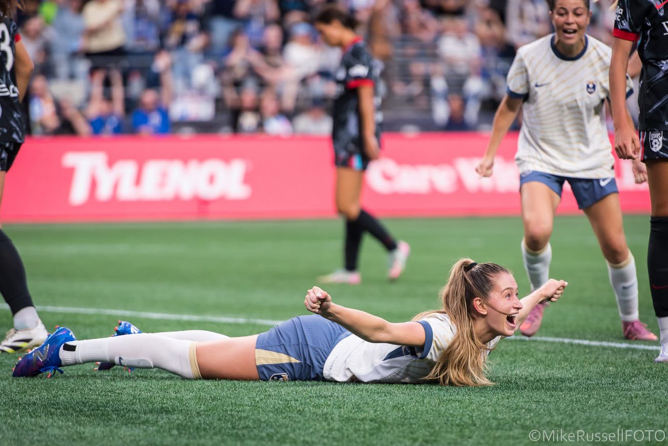 Reign forward Jordyn Huitema celebrates a bicycle kick goal from the ground in an August 2025 match against the Chicago Stars.