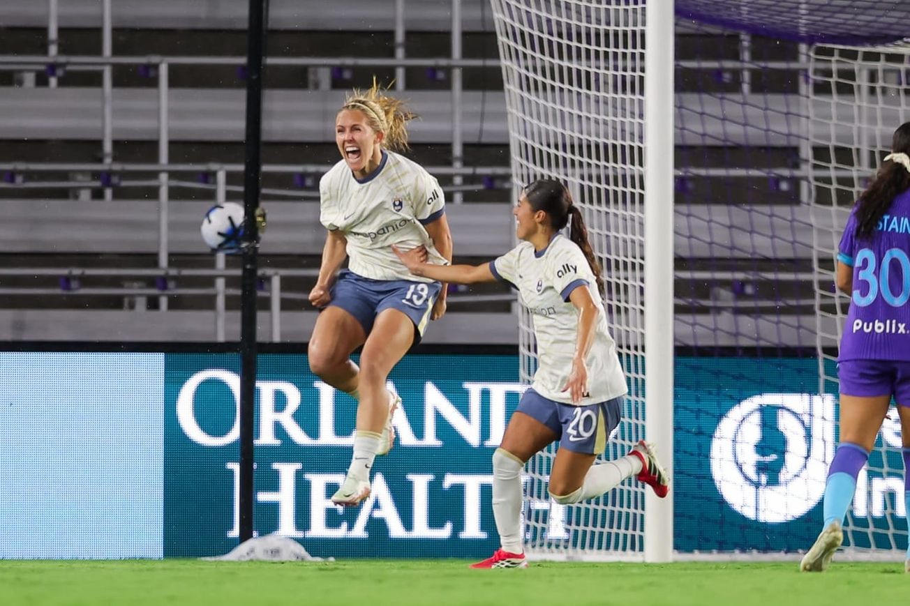 Brittany Ratcliffe jumps into the air after her game winning goal against the Orlando Pride as Sam Meza runs over to celebrate with her.
