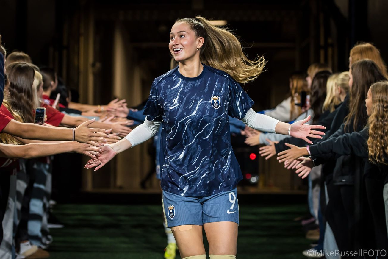 Former Reign forward Jordyn Huitema greets fans as she emerges from the tunnel for warmups ahead of a 2025 game at Lumen Field.