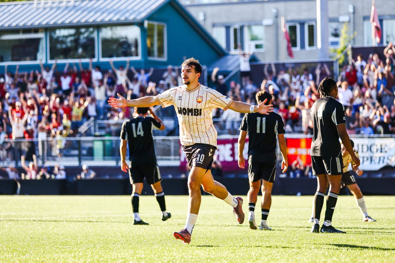 Ballard FC forward Joschi Schelb celebrates with his arms outstretched after scoring during a 4-3 USL League Two Western Conference semifinal victory over Colorado Storm.