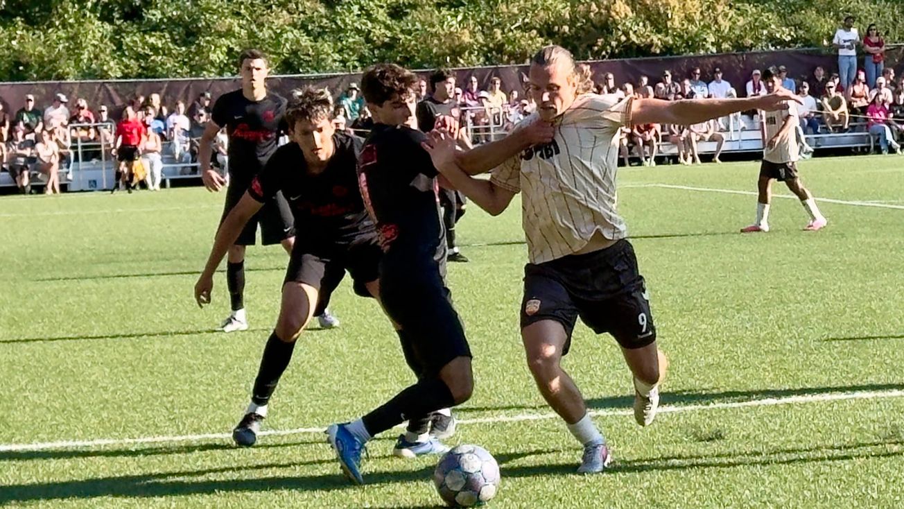Ballard FC forward Anton Hjalmarsson battles through a pair of Snohomish United defenders during Sunday’s 4-0 win at Interbay Stadium.