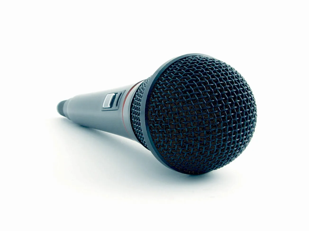 Close-up of a dynamic microphone against a white background. The microphone's mesh grille is prominent, highlighting its use for speech or music.