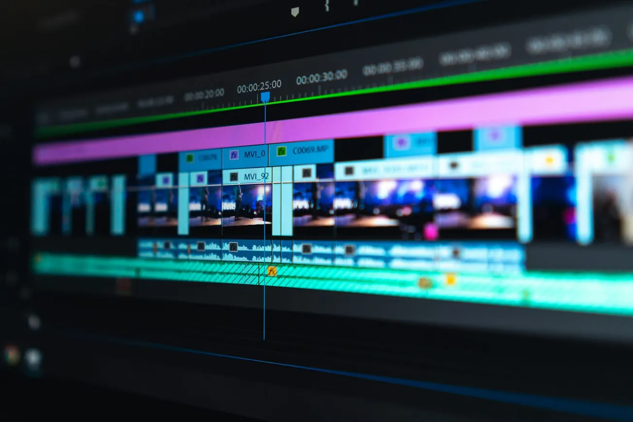 Close-up of a digital video editing timeline on a computer screen. The layout features various colorful tracks and clips, conveying a sense of technical activity.