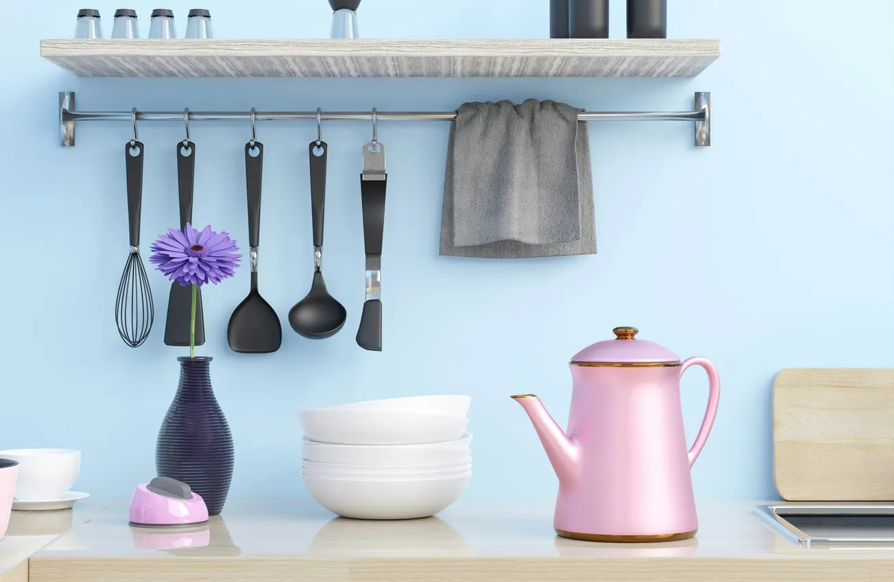 Kitchen scene with utensils hanging on a rack, a blue wall, a pink teapot on the counter, stacked white bowls, a purple vase with a flower, and a gray towel.