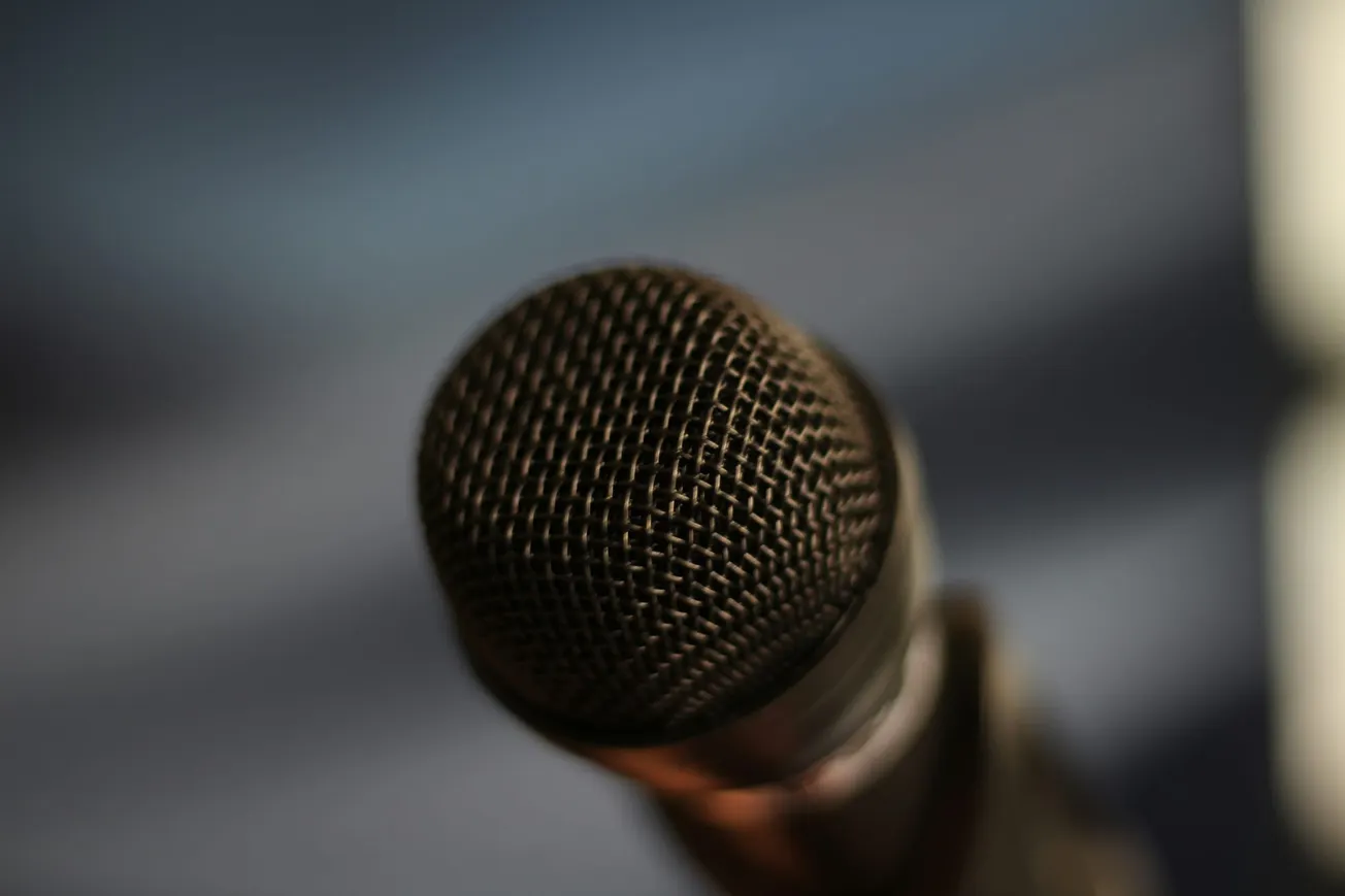 A close-up, shallow-depth-of-field view of the wire mesh grille of a professional vocal microphone.