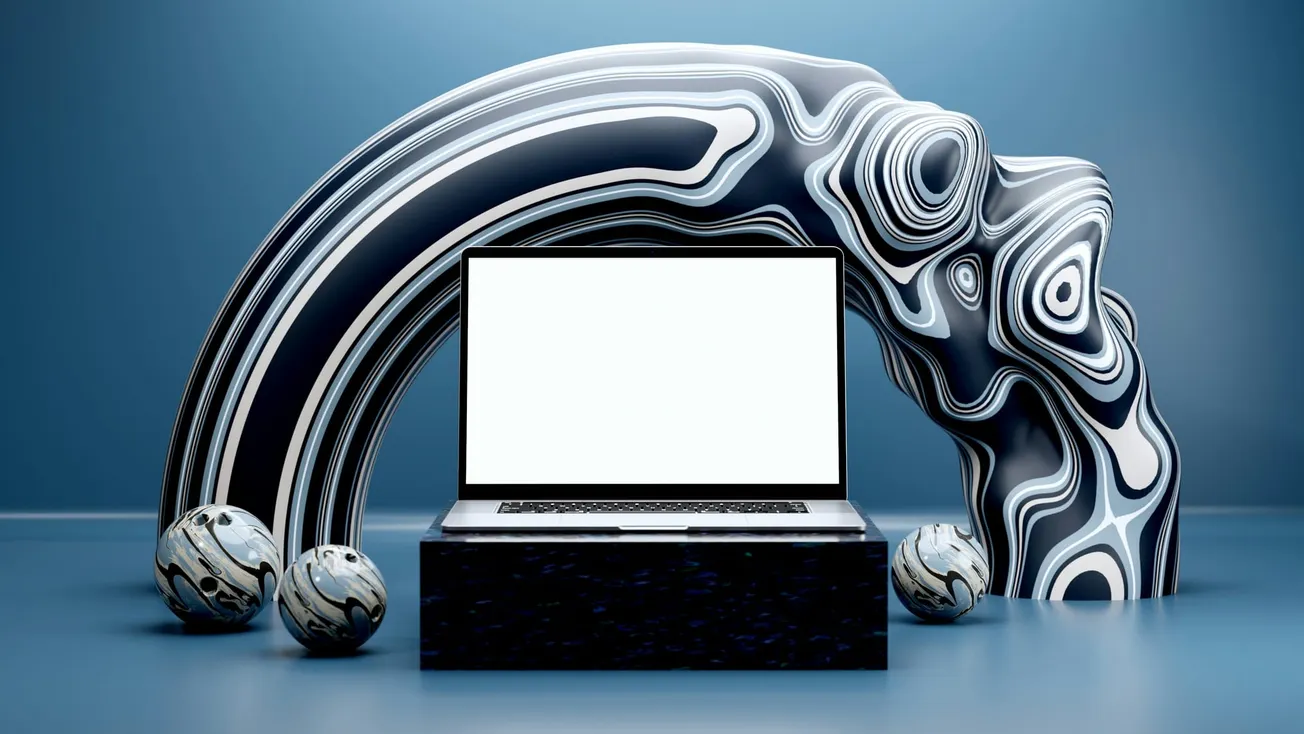 A laptop with a blank screen sits on a dark pedestal against a backdrop of wavy, black-and-white abstract patterns and three matching spheres, evoking modernity and elegance.