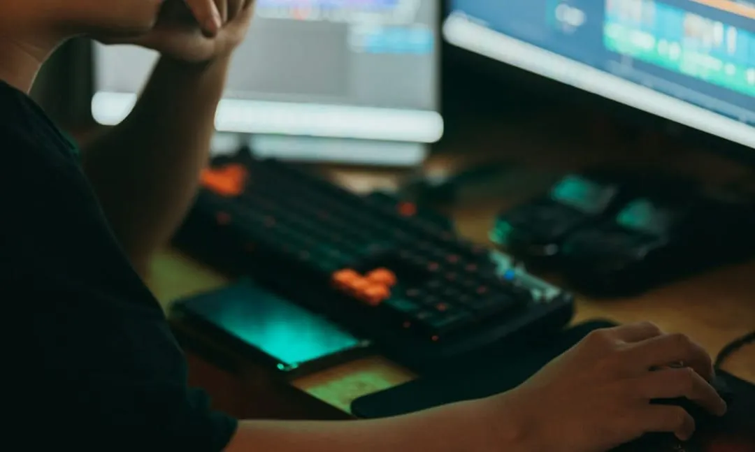 A content creator reviews editing software on a multi-screen workspace, highlighting strategic digital media planning.