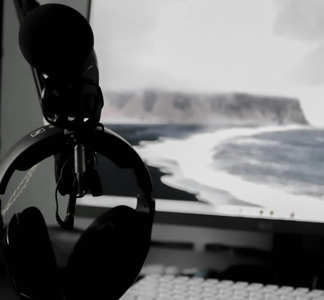 A creator in a modern podcast studio interacts with a holographic interface displaying AI-powered audio editing tools.