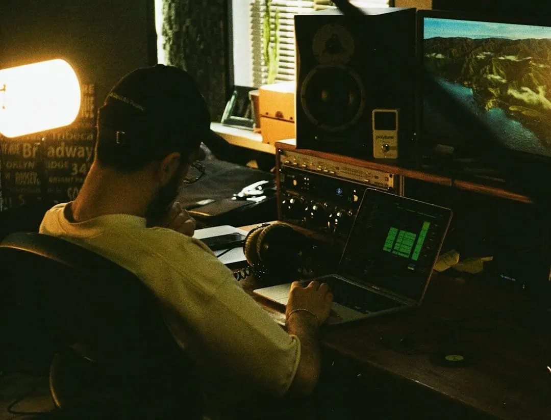 An audio engineer meticulously adjusts levels on a large mixing console, symbolizing precision in sound design and audio production.