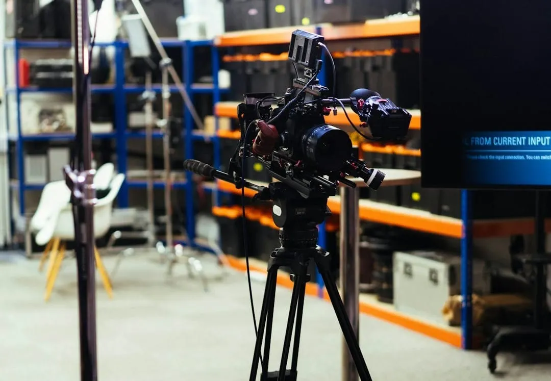 A professional videographer operates a Sony A7R VI mirrorless camera on a tripod, capturing high-resolution video in a modern studio environment for content creation.