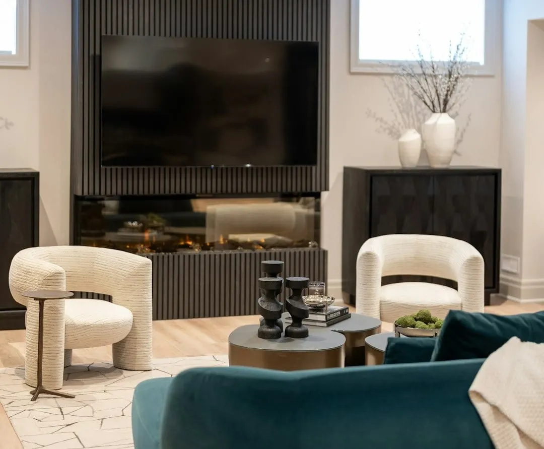 A modern living room features a diverse group of friends comfortably watching a video podcast together on a large smart television.
