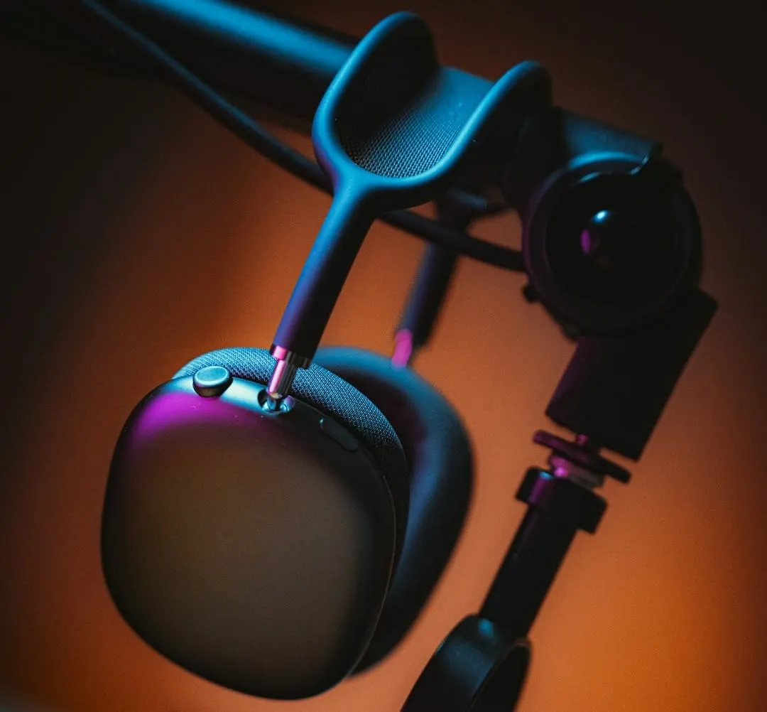 A modern HyperX FlipCast microphone stands in a studio environment with an Apple device showcasing AI-driven content tools.