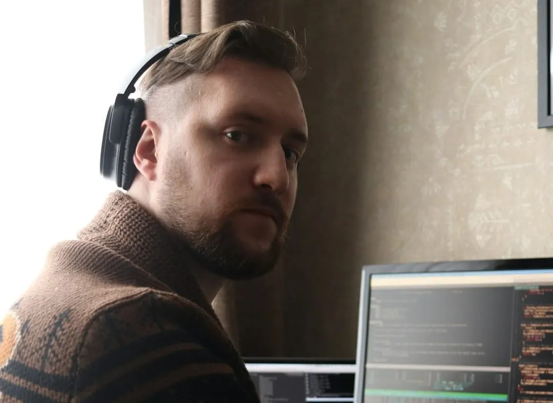 An audio engineer expertly mixes spatial audio using a professional digital audio workstation and an integrated Dolby Atmos renderer.