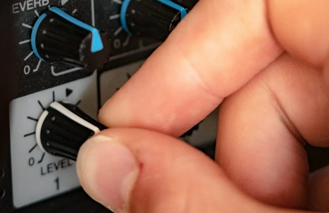 A skilled audio engineer meticulously adjusts digital audio workstation settings on a computer screen, enhancing sound quality.