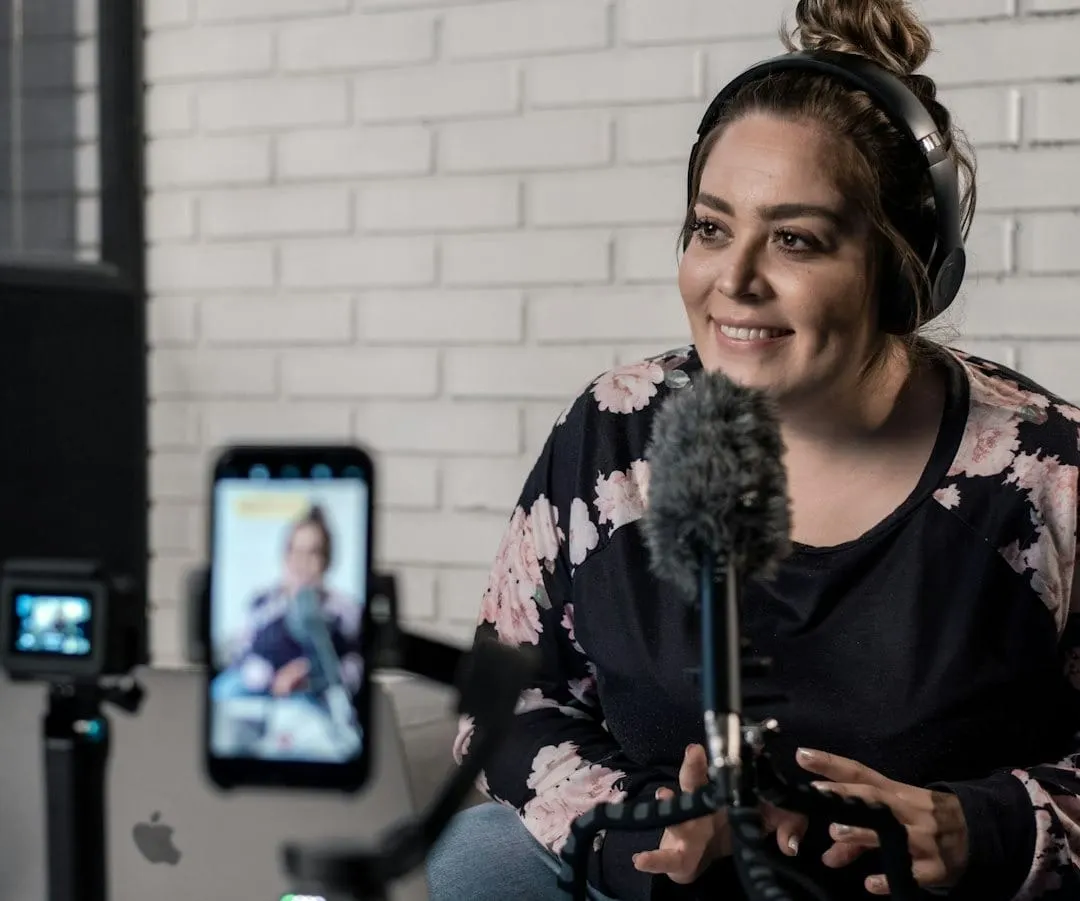 A creator analyzes podcast monetization data on a tablet, surrounded by professional audio equipment, symbolizing growth and strategic income generation.