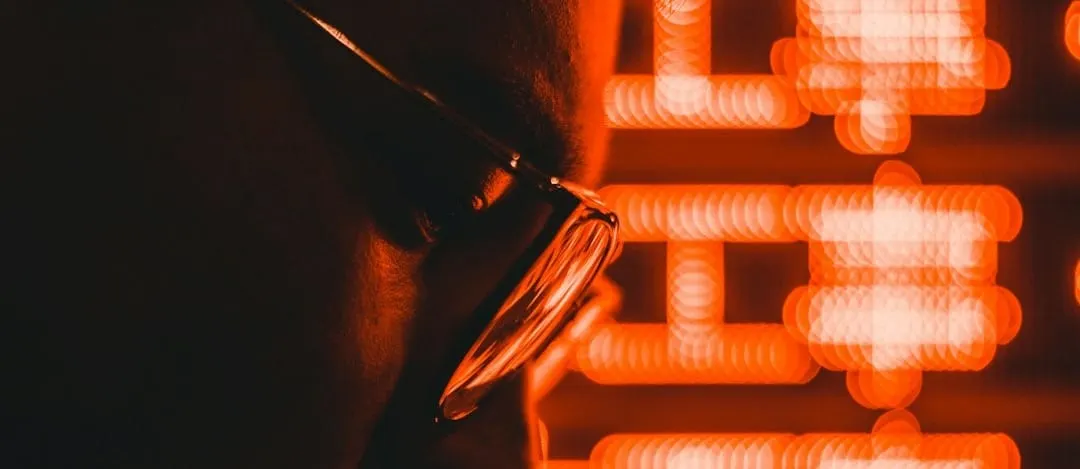 A creative professional analyzes data insights on a screen, integrating artificial intelligence and community feedback for enhanced content strategy.