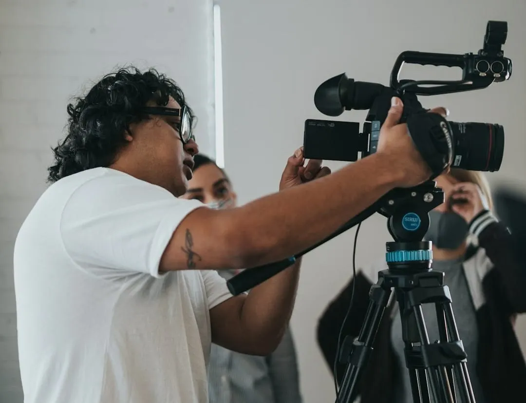 A diverse team of content creators actively collaborating on a podcast and video project in a contemporary production studio.
