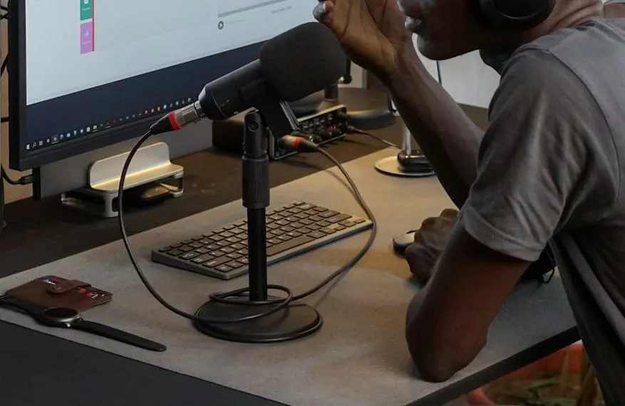 A professional podcaster actively speaks into a studio microphone, wearing over-ear headphones, illustrating effective audio storytelling and content creation.