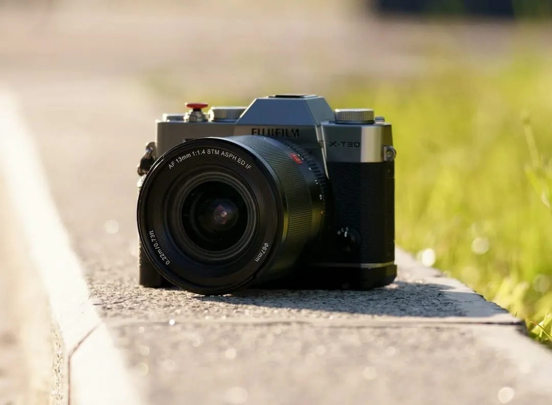 A Viltrox AF 26mm F2.8 EVO compact pancake lens is securely mounted on a Sony E-mount mirrorless camera, ready for professional content creation.