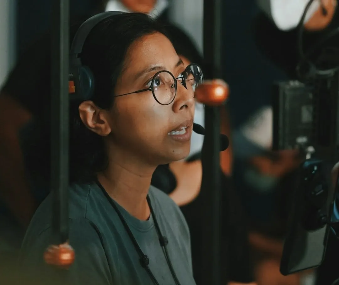 A group of content creators working in a dynamic studio, showcasing video podcasting production with advanced editing software.