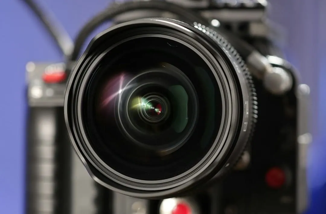 A high-speed professional video camera lens is sharply focused, capturing a dynamic, motion-blurred subject, symbolizing advanced data visualization and content creation.