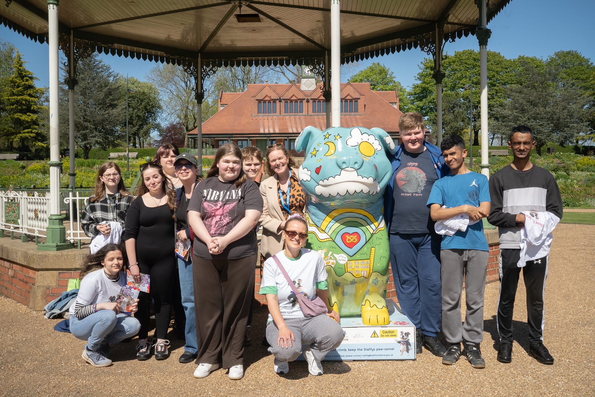Abbey Hill Academy College Students with artist, Chloe Breeze, next to 'Sonney' Staffy sculpture at Hanley Park in Stoke-on-Trent