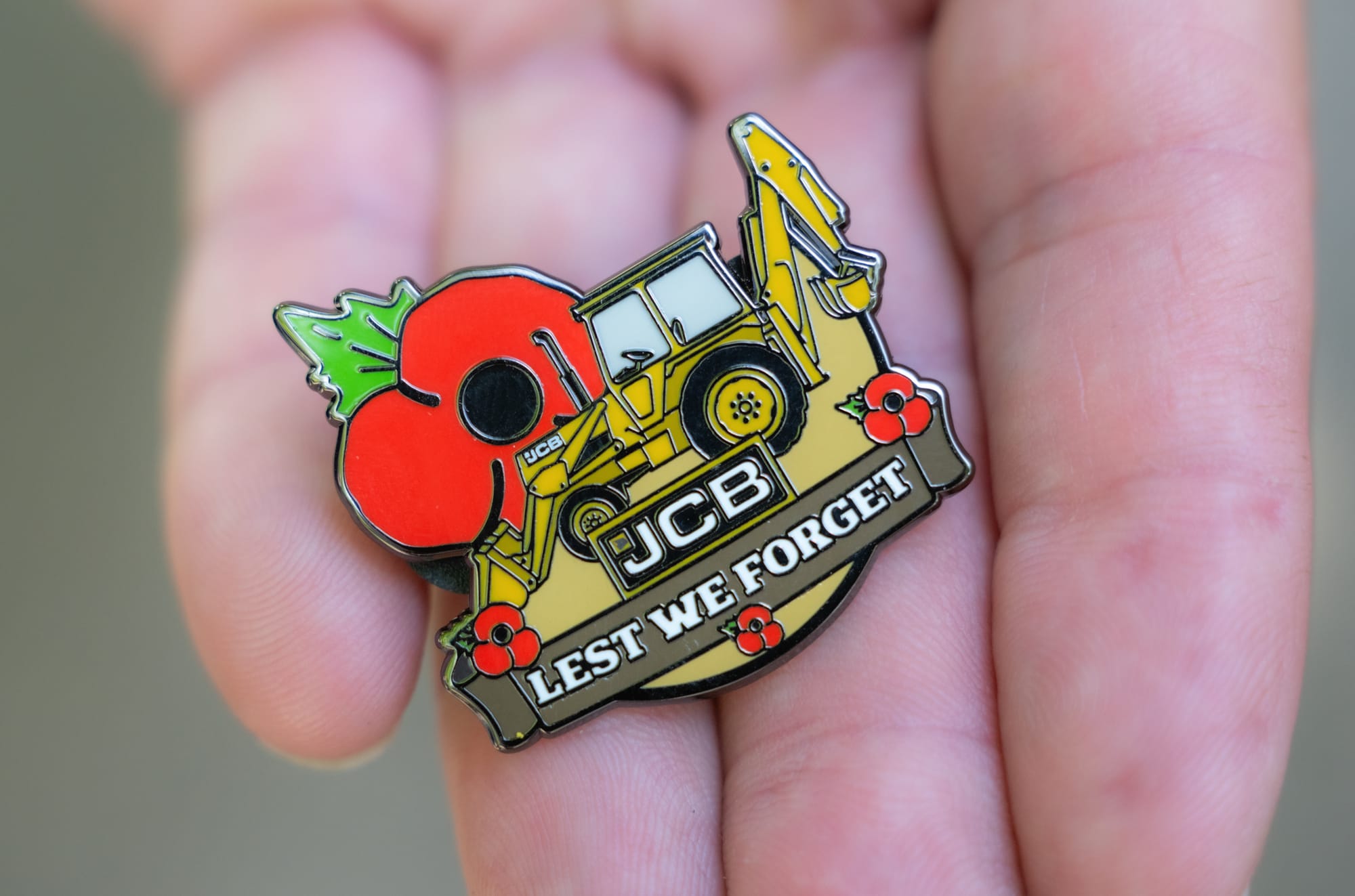 Retired Firefighter Digs Deep for Poppy Appeal With JCB Badge