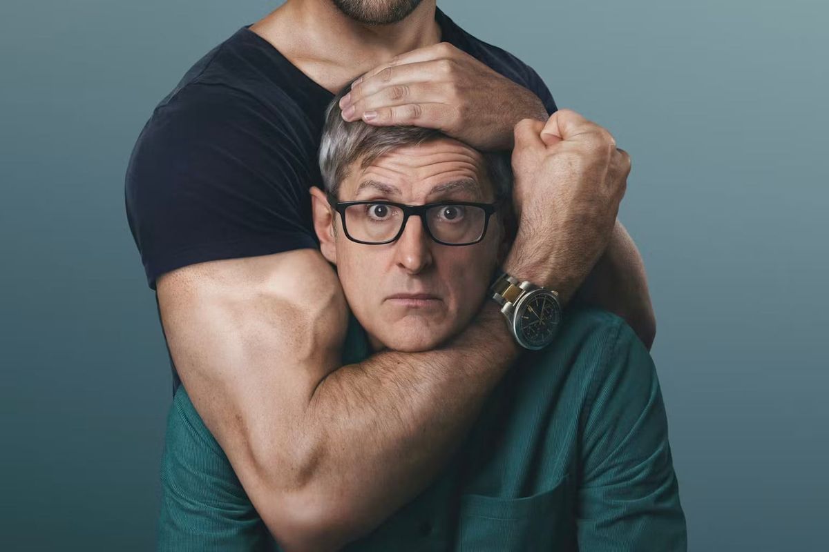 Louis Theroux is held in a headlock by a man representative of the Manosphere
