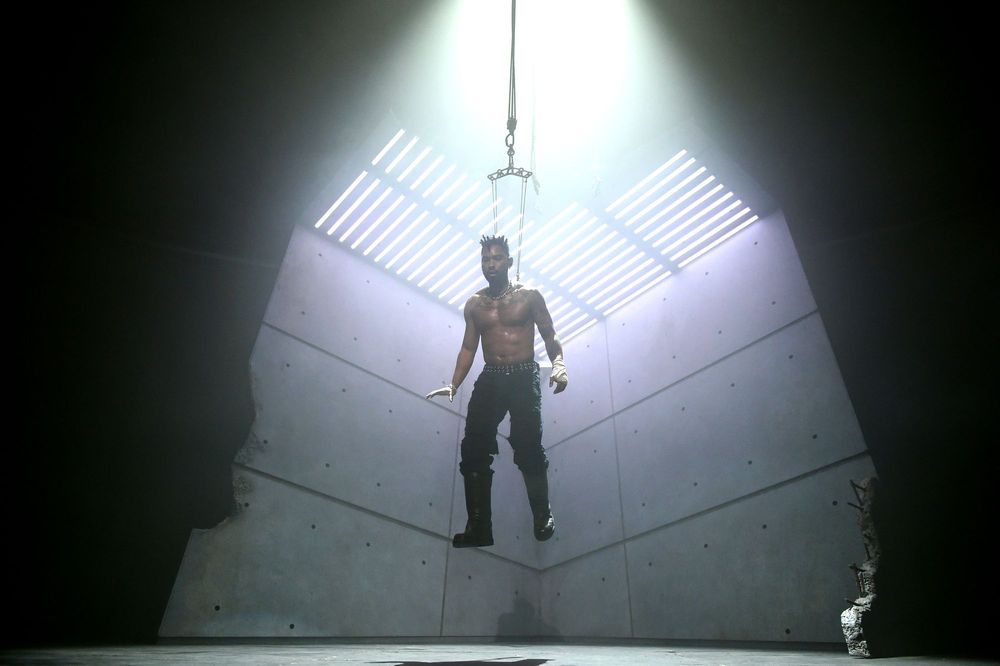 Miguel hanging by hooks in his back while performing "Rope" via body suspension